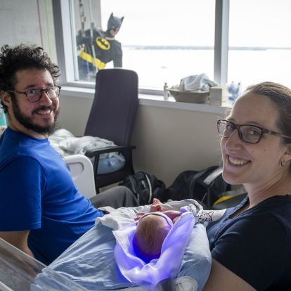 Elite Window Washing Superhero Image of a superhero window washer with family on peds