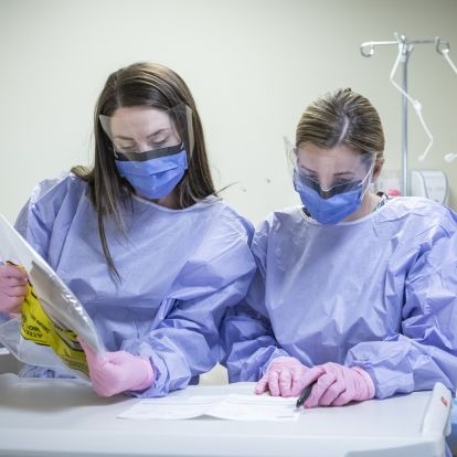 Staff examine cancer medication.