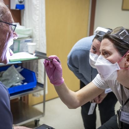 A speech language pathologist examines a patient