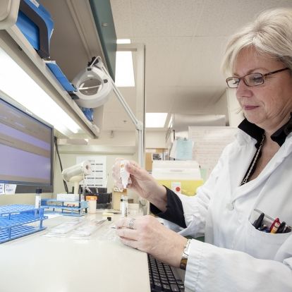 Sam Miller, Medical Lab Technologist perpares samples for testing inside the microbiology laboratory at Kingston General Hospital.