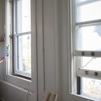 Luis Fernandez from Alwind Industries (left) helping install new windows on Watkins 5.