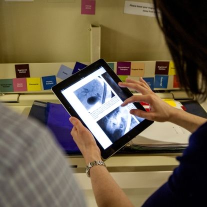 Dr. Catherine Barry uses her new iPad to review imaging files for patients on one of the units at KGH.