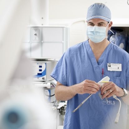 A surcial equipment supplier standing in the OR