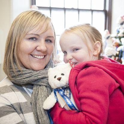 Five-year old patient Aly Davis and her mother Audrey Jones stopped by the Watkins lobby to help launch this year's "Show Children You Care" Teddy Bear campaign.