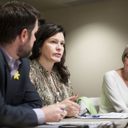 KGH Patient Experience Advisors Marla Rosen and Barb Girard speak with staff at a program council meeting.