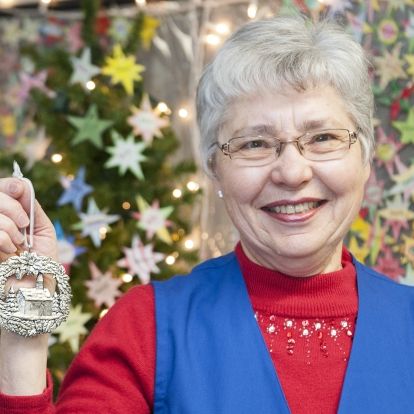 Merna Manders, co-convenor of the Auxiliary's Patient Comforts Committee, shows off the ornament that will be given out to patients this Christmas Eve.