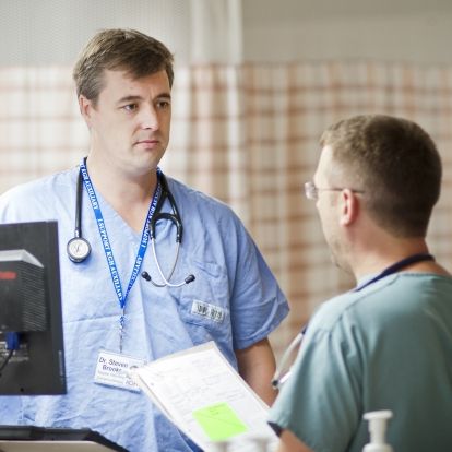 Dr. Steven Brooks talking to a colleague in the Emergency Department at KGH.