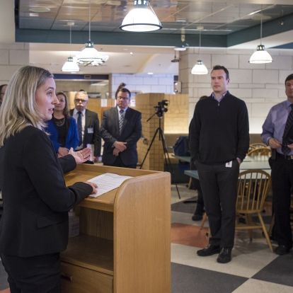 Community stakeholders and media gather for the energy savings event