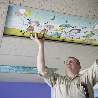Doug Kennedy, Mechanic, was busy installing the nine ceiling tiles now up in the Pediatrics unit.