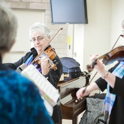 Members of the Triola Trio, Gisele Dalbec Szczesniak (centre), Melinda Raymond (right) and Eileen Beaudette (left) entertained listeners in the Burr lobby with their version of Journey's hit "Don't Stop Believin."
