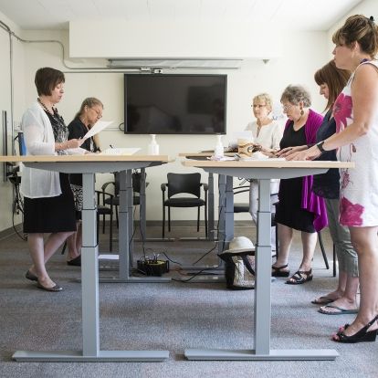 The Dietary 2 conference room is the scene of a new style of meeting where chairs are pushed aside.