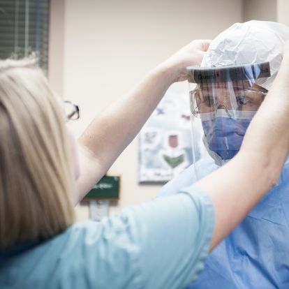 Staff at Kingston General Hospital work together in pairs and train on how to properly use enhanced personal protective equipment.