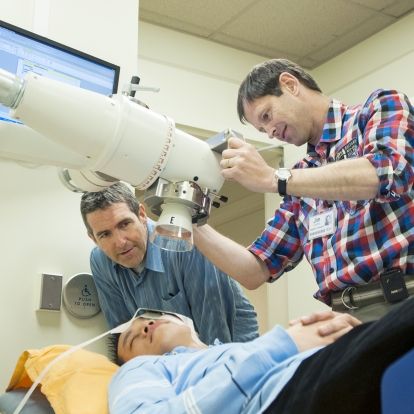 Radiation Therapists David Markotich (left) and Jim Gooding demonstrate how to prepare a patient for radiation treatment using KGH’s new orthovoltage machine.