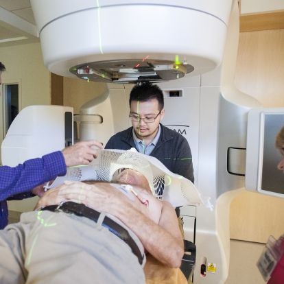 Members of the Radiation Therapy team make adjustments to the cancer centre’s new Linear Accelerator for patient Lance Sheppard