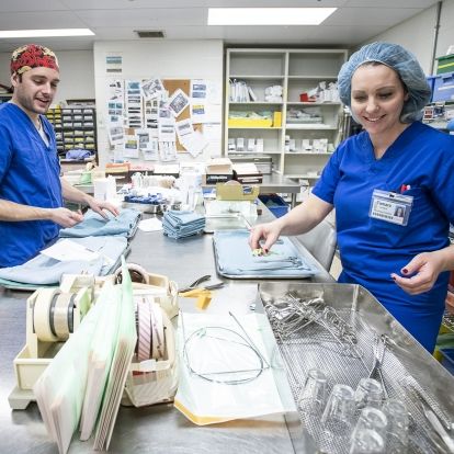 Technicians working to sterilize surgical equipment