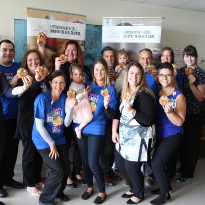 KHSC and UHKF staff along with former NICU patients and Tim Hortons owners kick off the smile cookie campaign