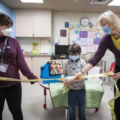Robbie cutting the ribbon to his treasure chest