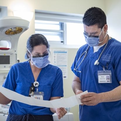 nurses reviewing fetal monitor tape