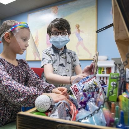 Robbie and a friend exploring all of the treasures inside the treasure chest