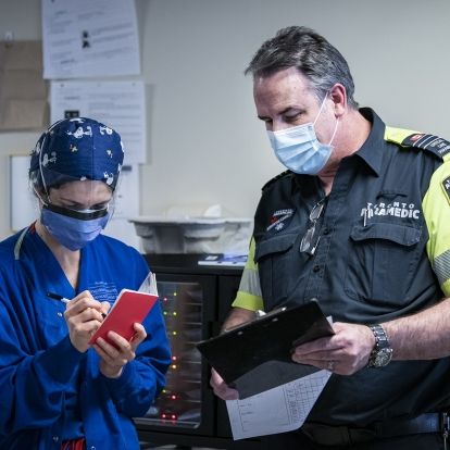 KHSC ICU staff working with Toronto paramedics to transfer patient care