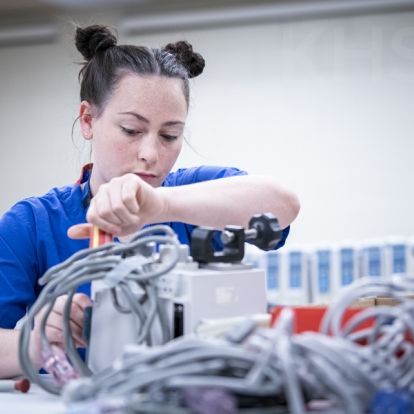 Madeline Rozsa, a Biomedical Technologist with the Clinical Engineering team works on some of the old units as part of the decommissioning process.