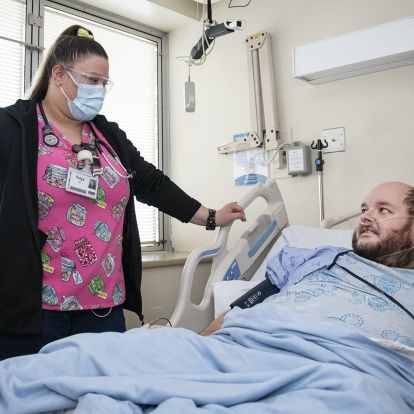 Allworth with nurse in KHSC Covid unit