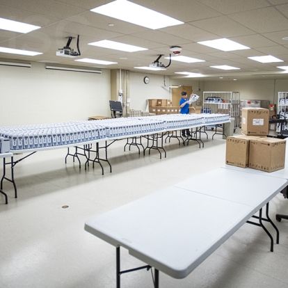 Staff from BD work at the KGH site unloading pallets of new pumps and unpacking each unit before testing and certification for deployment.