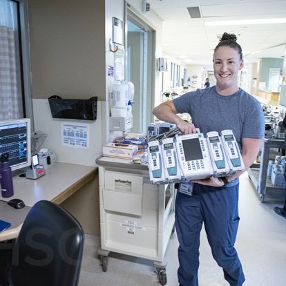 Kadie Weekes, a Critical Care Nurse on Davies 4 ICU receives a new Alairs Infusion controller with pump modules during the implementation phase of the project.