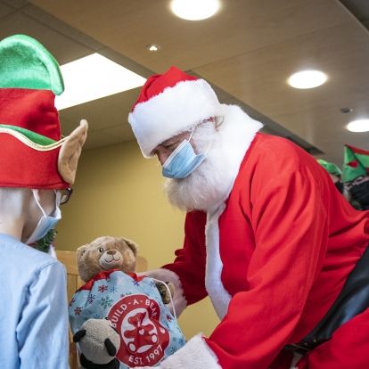 Santa distributes toys donated by the Royal Canadian Air Force to pediatric patients at KHSC