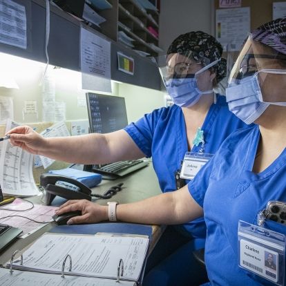 nurses reviewing monitor results