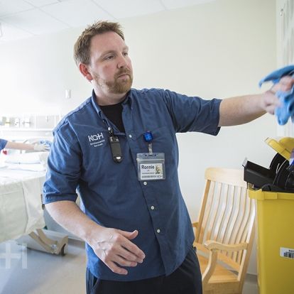 Environmental Assistants Ronnie Lott and Melissa Sauve clean all of the surfaces in a patient care room on Kidd 10.
