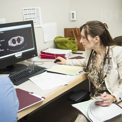 Dr. Genèvieve Digby meets with a team to discuss a care plan for a patient visiting the clinic immediately after being diagnosed with lung cancer