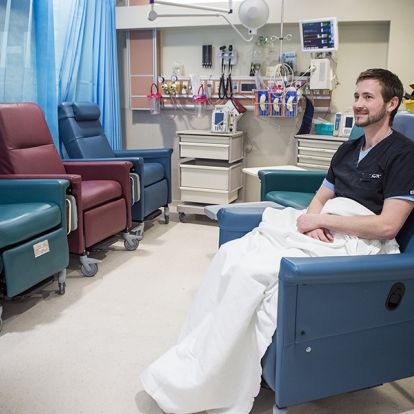 Drew Henson, Registered Nurse, demonstrating how the new lounge chairs work in the ED.