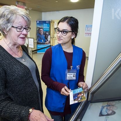 A patient in the Cancer Care centre at KGH learns about the new kiosks.