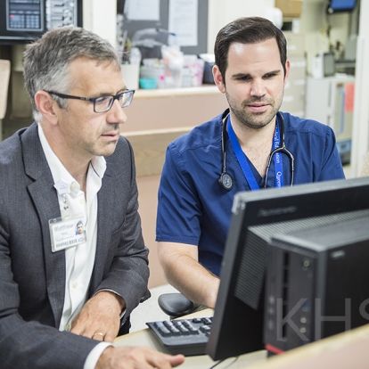 Dr. Damon Dagnone and resident Dr. Aaron Ruberto take a look at the new online system that will be used to provide feedback to residents
