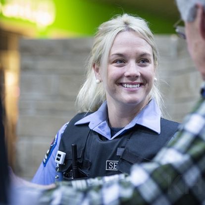 Security Guard Brittani Roberts meets with volunteers at the information desk in the main lobby of our KGH site
