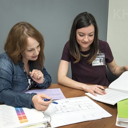Angela Hollett, left, and her colleague Brittany examine plans for a future milk-prep room at KHSC.