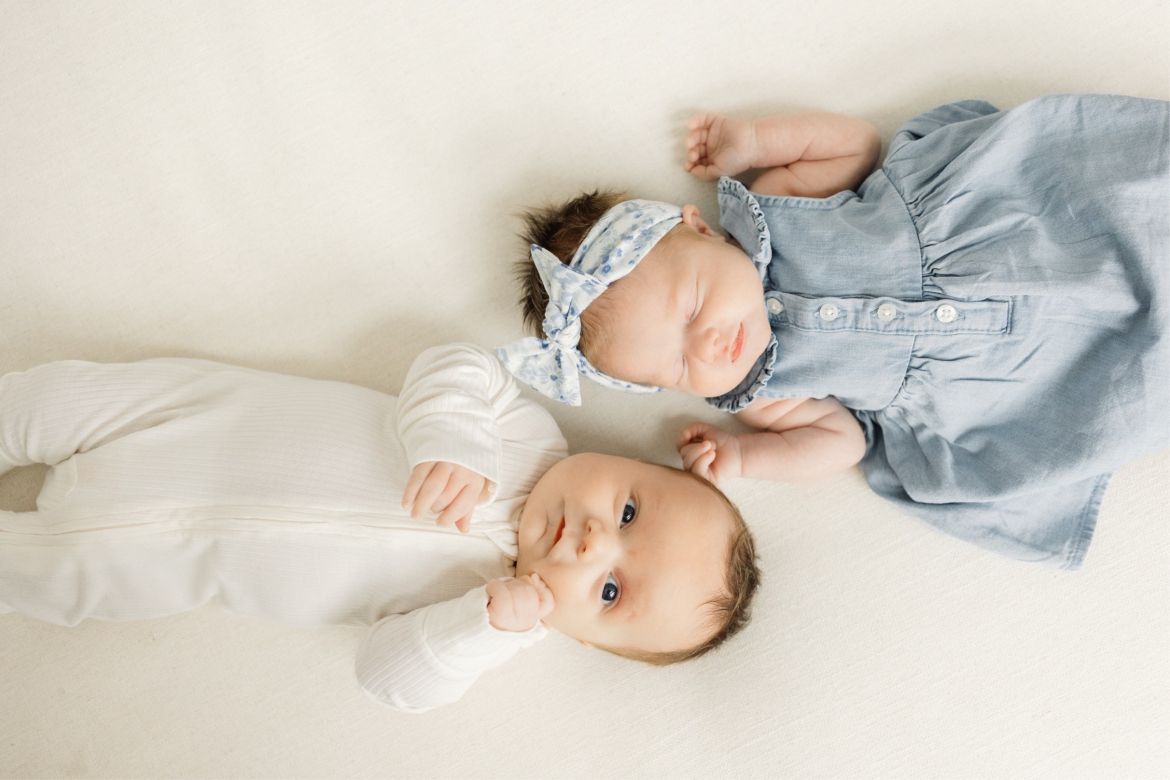 two young babies laying side by side