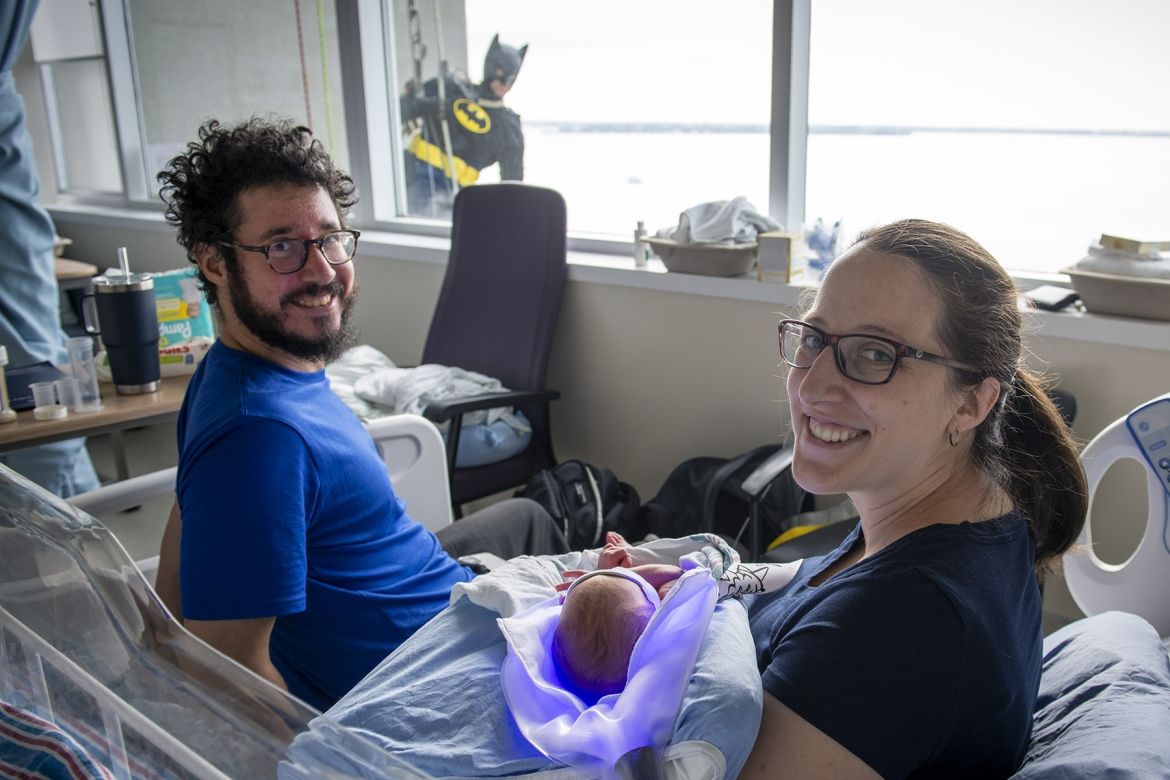 Elite Window Washing Superhero Image of a superhero window washer with family on peds