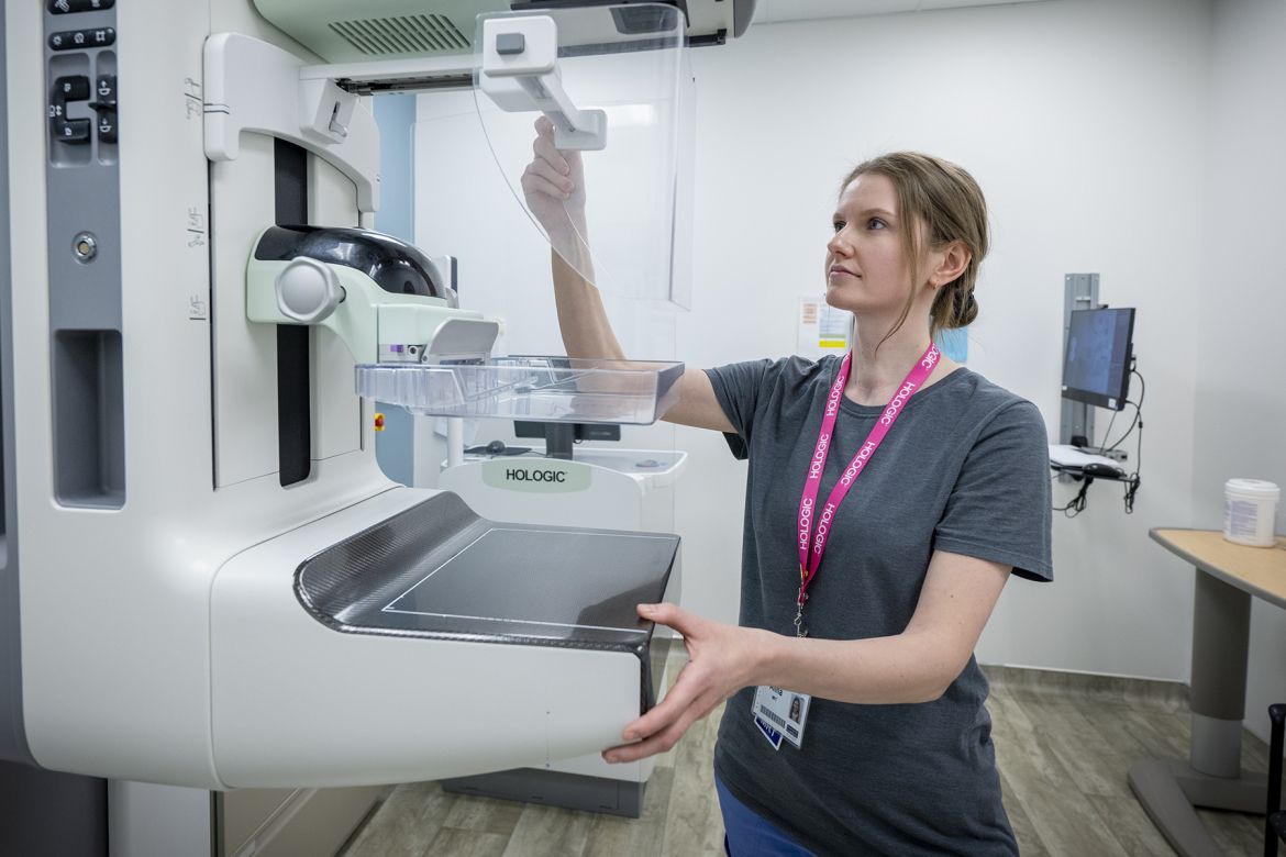 A technologist operating a mammogram