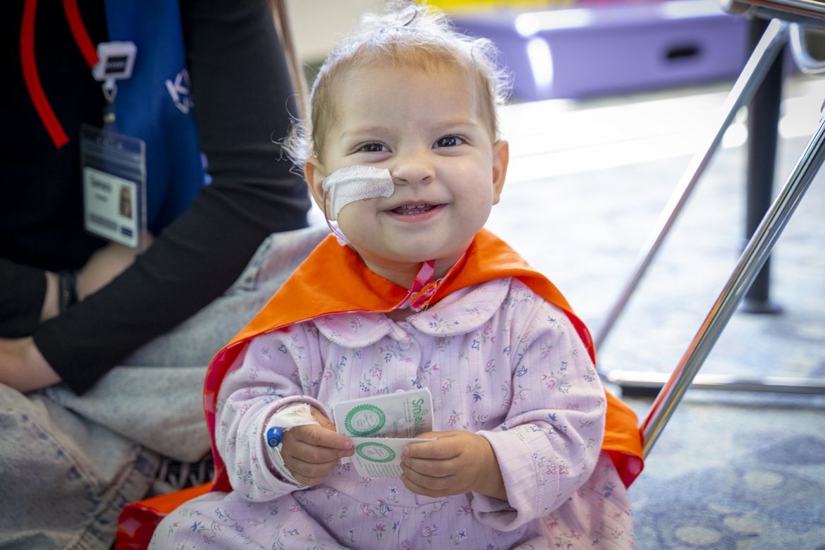 baby in an orange cape