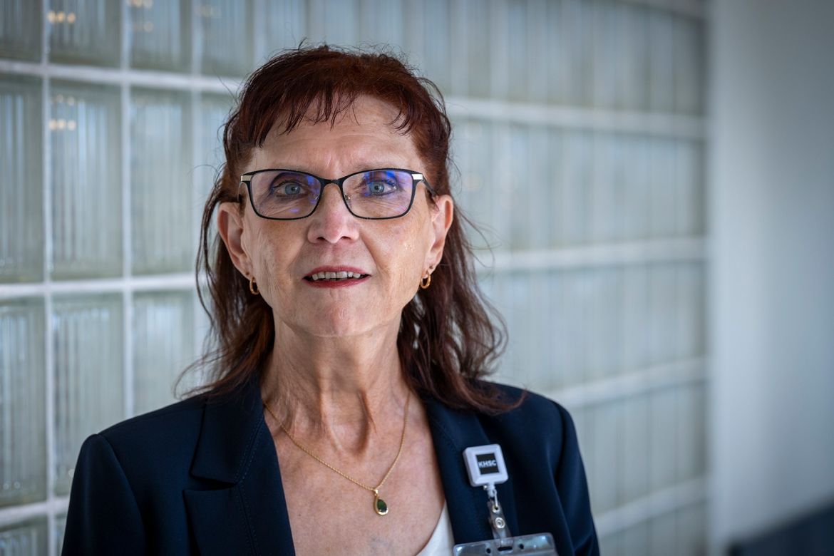 Margaret Bollen Margaret Bollen is pictured standing in a hallway at Kingston General Hospital. She has auburn hair, blue eye hair and wears glasses. She’s wearing a dark navy suit and white top, and is looking directly into the camera.