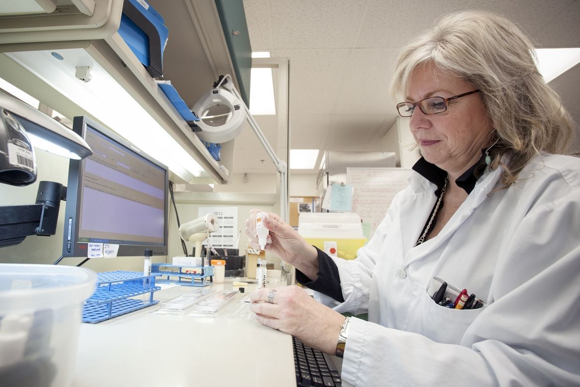 Sam Miller, Medical Lab Technologist perpares samples for testing inside the microbiology laboratory at Kingston General Hospital.