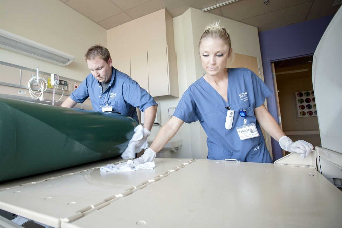 (From left) Environmental Assistants Ronnie Lott and Zabrina Ferguson work to ensure each patient room is cleaned to the highest standard.