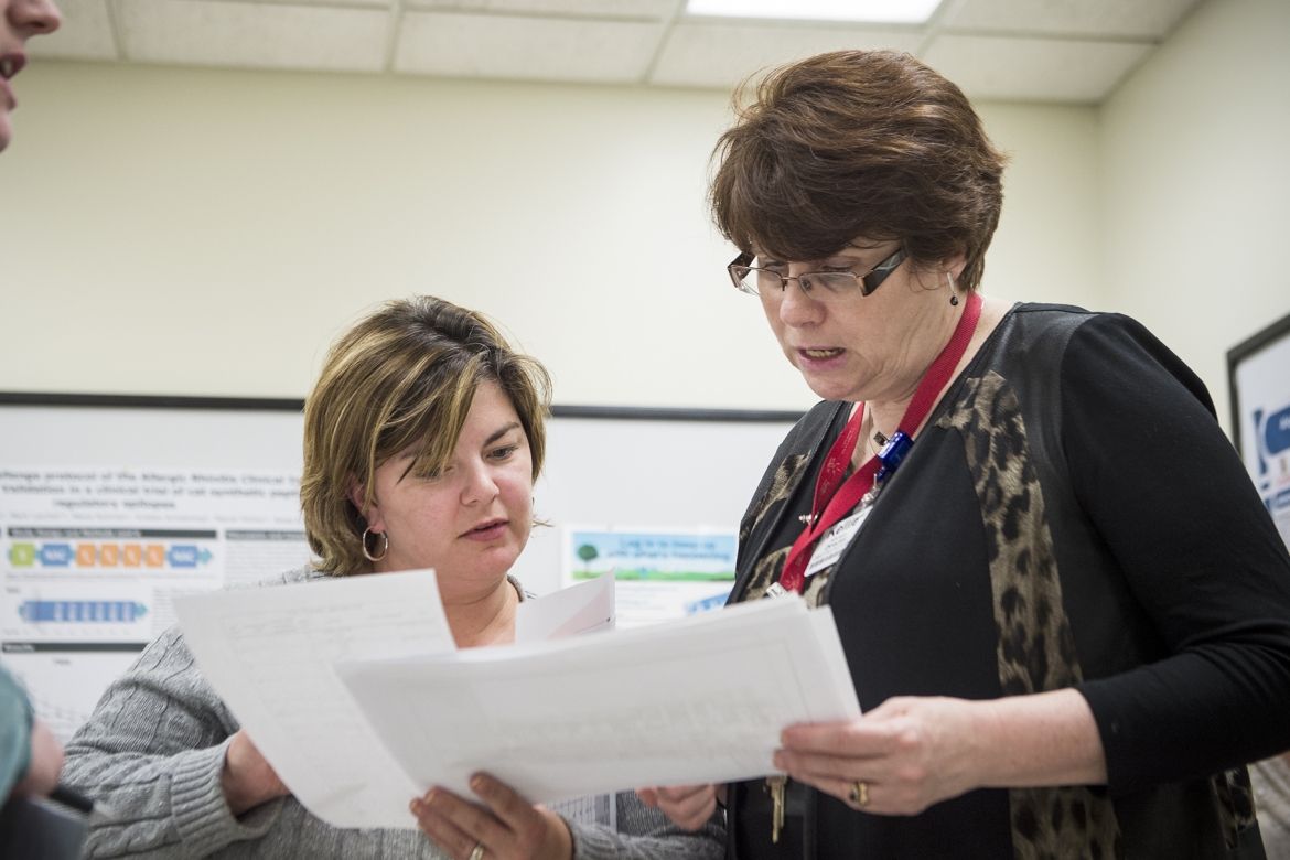 (From left) Rachael Smith-Tryon, Manager of Admitting, Registration and Switchboard and Kellie Kitchen, Program Operational Director for OBS/GYN/PEDS/SPA, have a quick meeting as part of the daily huddles