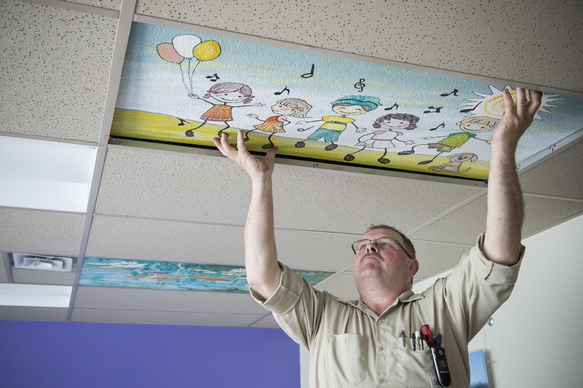 Doug Kennedy, Mechanic, was busy installing the nine ceiling tiles now up in the Pediatrics unit.