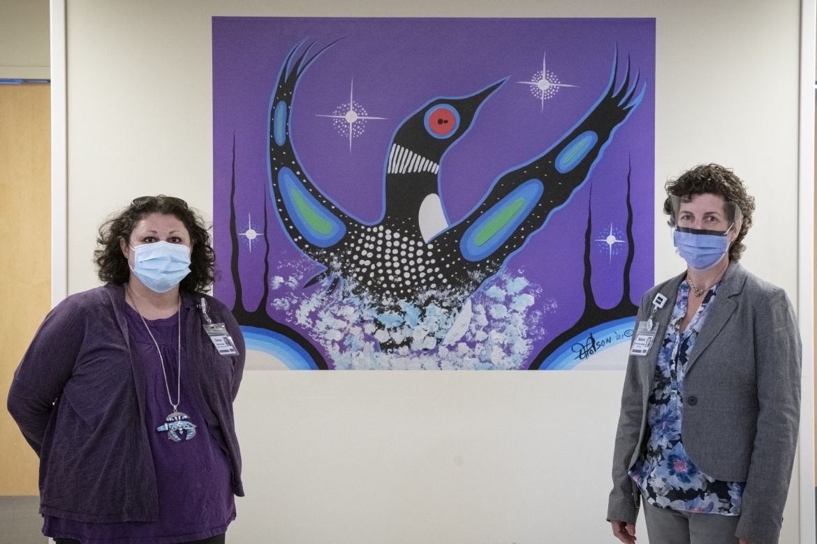 staff posing with art work