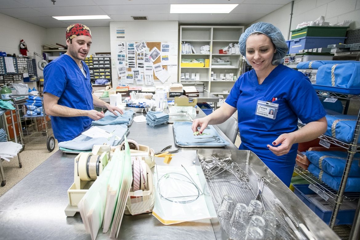 Technicians working to sterilize surgical equipment