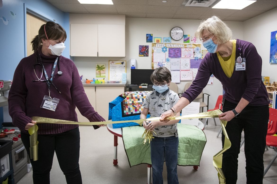Robbie cutting the ribbon to his treasure chest