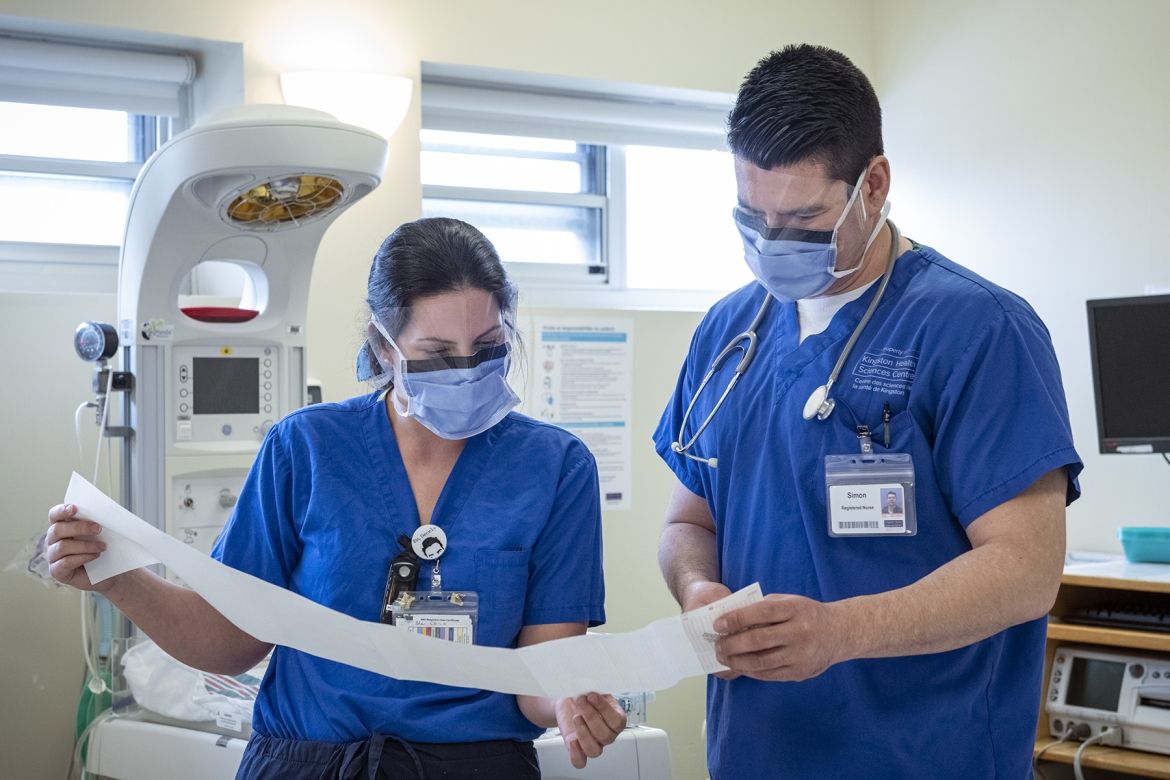 nurses reviewing fetal monitor tape
